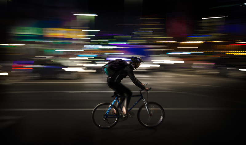 Cyclist biking at night wearing helmet